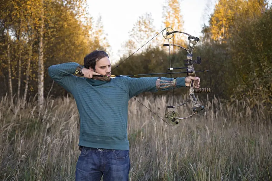 Shooting compound bow in woods